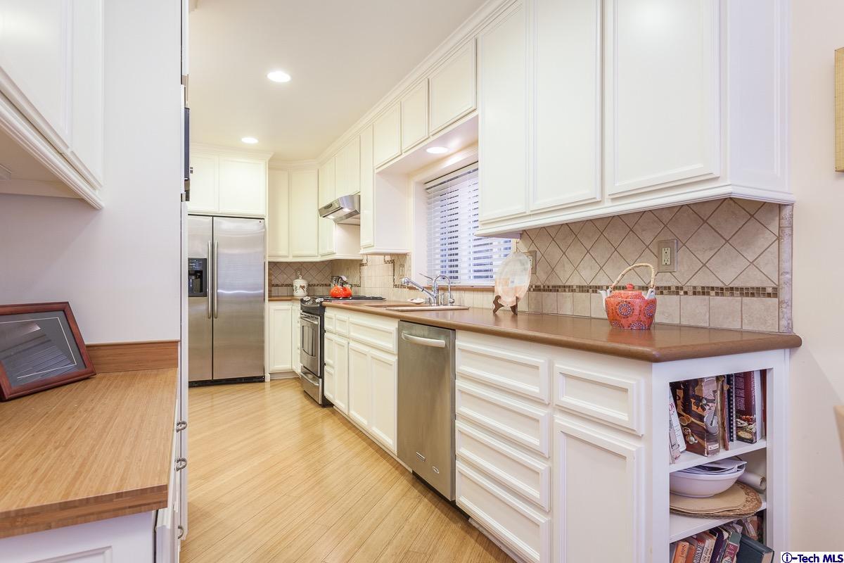 44 San Miguel Road Pasadena, CA 91105 - Photo 9 of 18 a kitchen with stainless steel appliances granite countertop a refrigerator sink and cabinets
