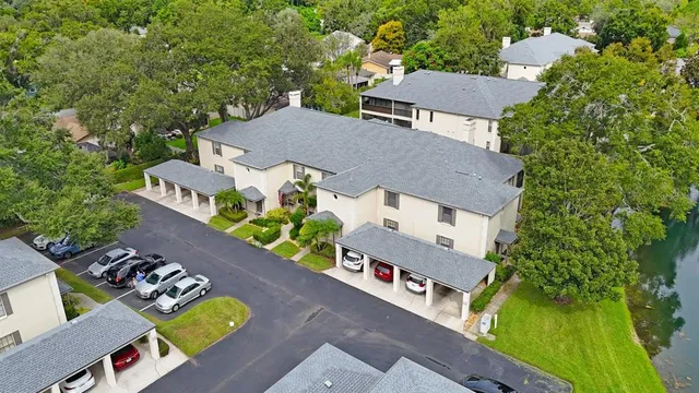 an aerial view of a house with swimming pool and porch