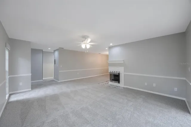 wooden floor in an empty room with a fireplace