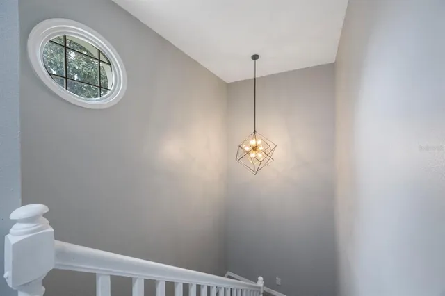 a view of an empty room with a window and cabinet