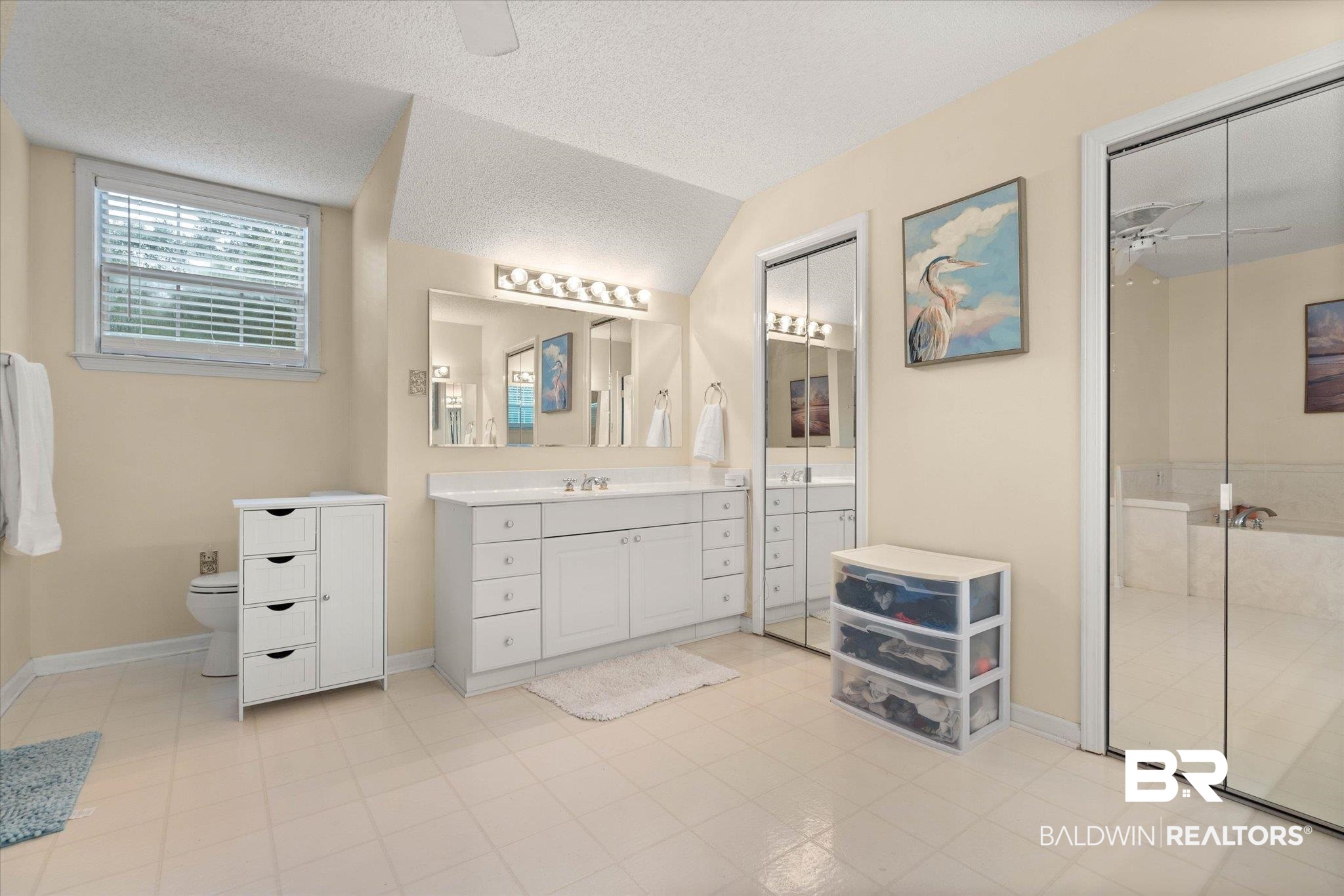 2300 Radcliff Road Saraland, AL 36571 - Photo 25 of 56 Full bathroom with vanity, a textured ceiling, a shower, vaulted ceiling, and tile patterned flooring