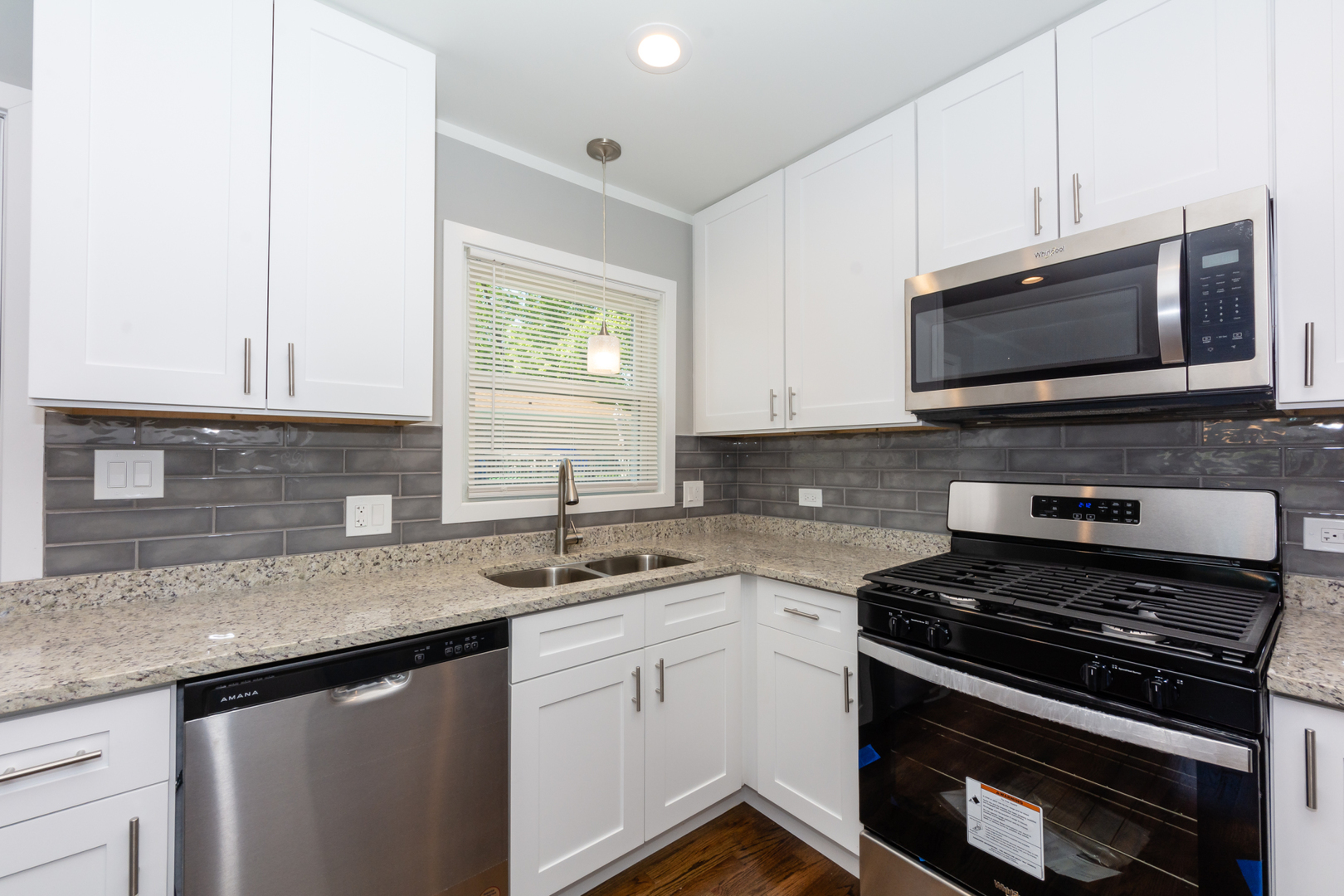 2840 140th Street Blue Island, IL 60406 - Photo 8 of 16 a kitchen with granite countertop a stove sink and microwave