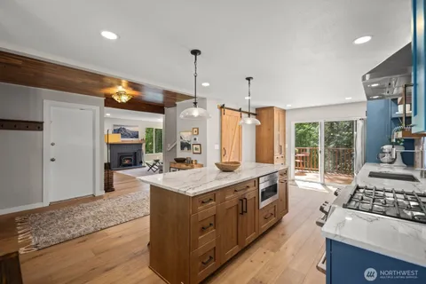 a kitchen with stainless steel appliances granite countertop a stove and a sink