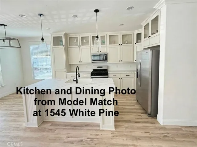 a view of kitchen with refrigerator and window