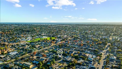 a front view of a house with a garden and yard