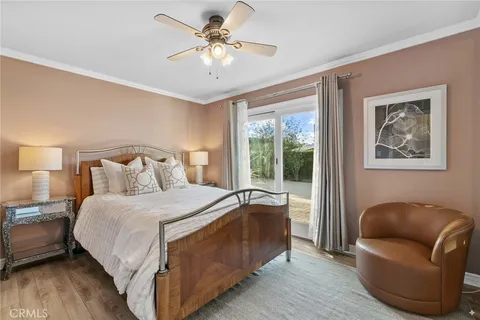 a bedroom with a bed couch and a window