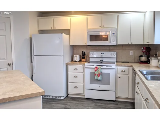 a kitchen with appliances cabinets and a counter top space