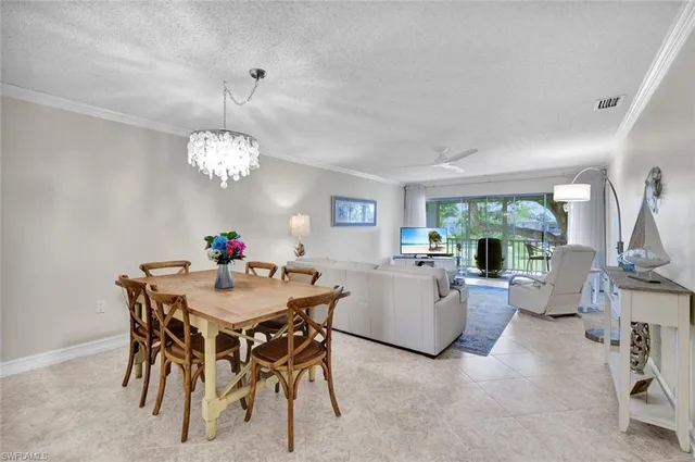 a view of a dining room with furniture and a chandelier