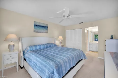 a bedroom with a bed and a lamp