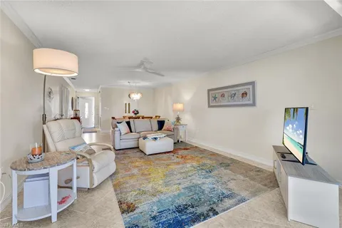 a living room with furniture and a lamp