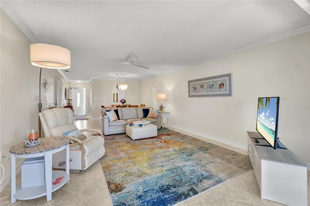 a living room with furniture and a lamp