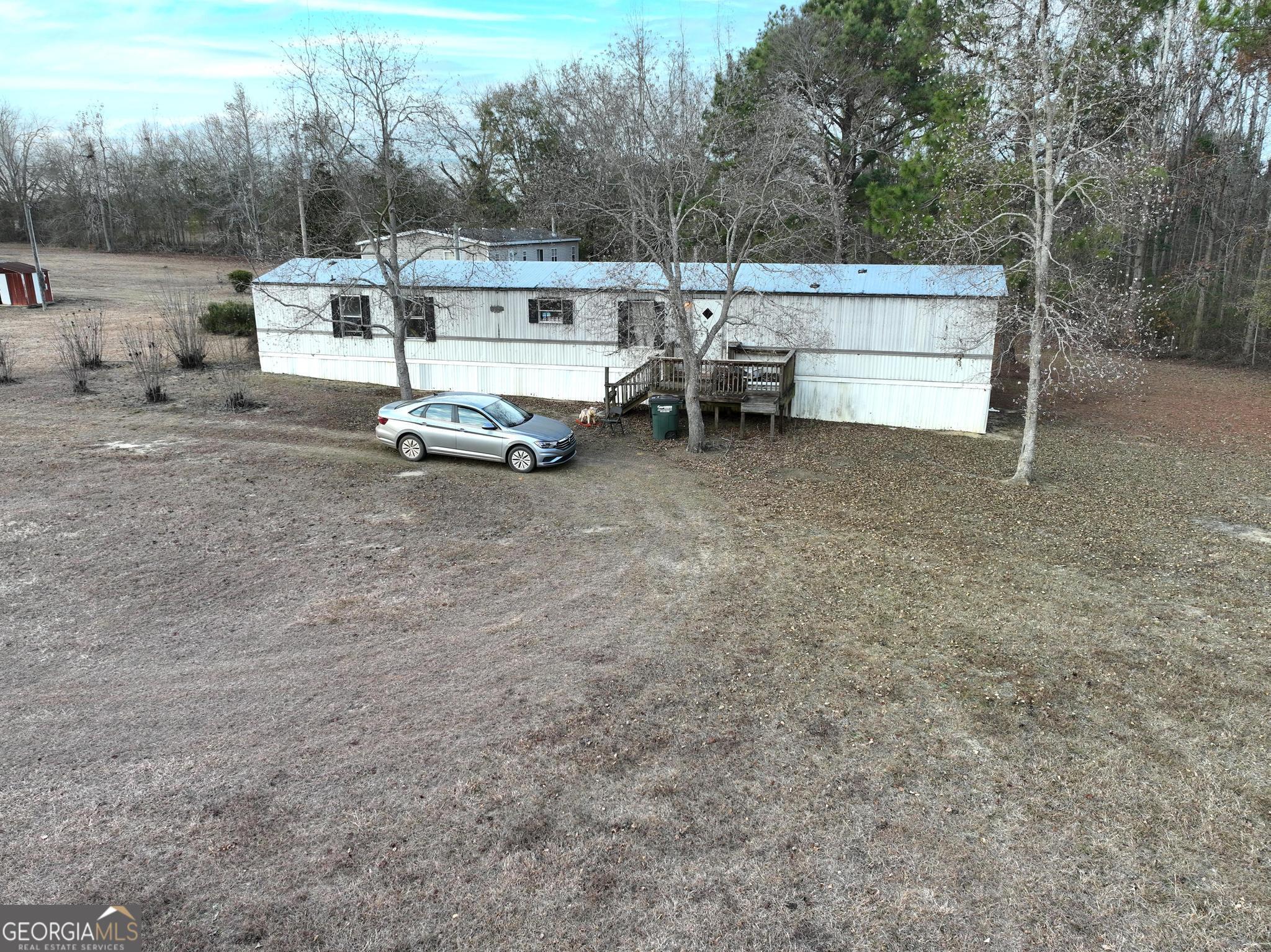 1500 Mallard Road Cobbtown, GA 30420 - Photo 17 of 20 a view of a white house with a yard and sitting area