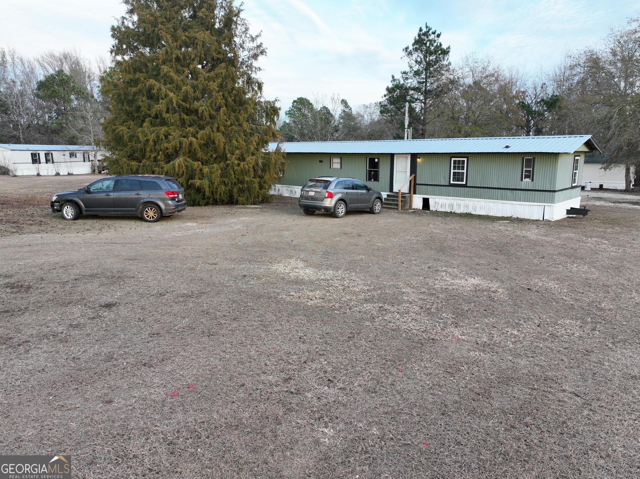 1500 Mallard Road Cobbtown, GA 30420 - Photo 10 of 20 a car parked in front of house