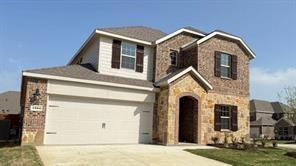 Two-story residence featuring a combination of brick and stone facade, an arched entryway, and a two-car garage