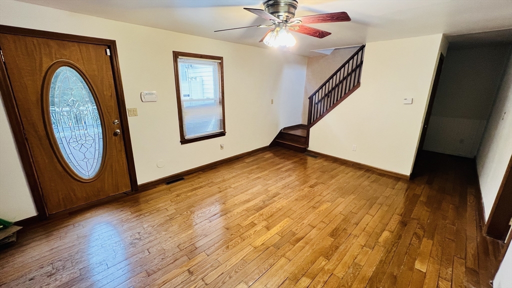 67 Amherst Road, Unit 67 South Hadley, MA 01075 - Photo 18 of 27 a view of a livingroom with wooden floor and a staircase