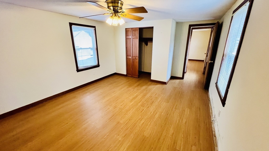 67 Amherst Road, Unit 67 South Hadley, MA 01075 - Photo 20 of 27 a view of an empty room with wooden floor and a window