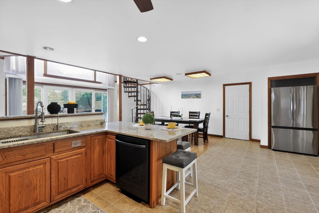 67 Amherst Road, Unit 67 South Hadley, MA 01075 - Photo 5 of 27 a kitchen with a sink a counter top space and stainless steel appliances