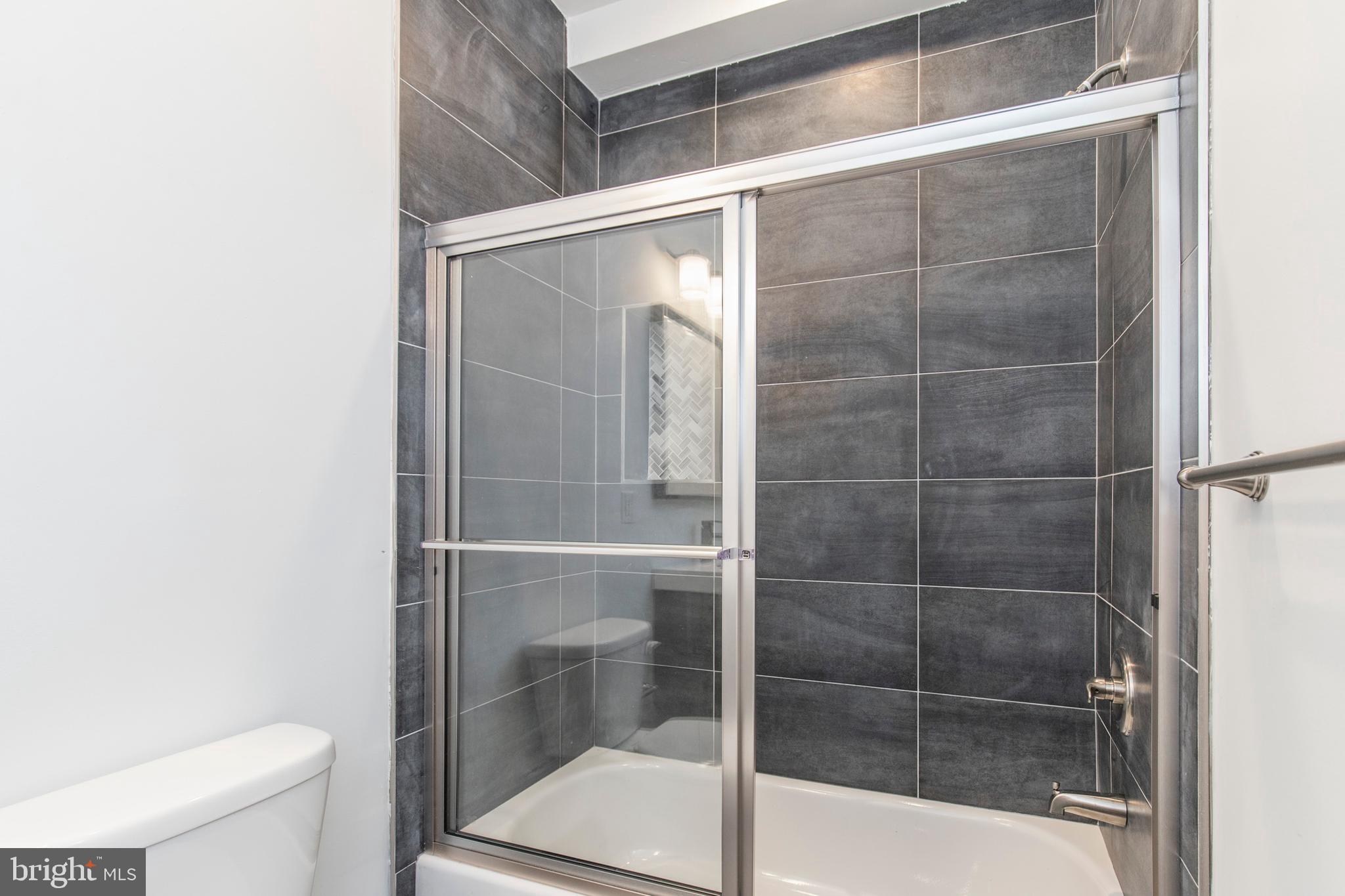 2412 Master Street, Unit A Philadelphia, PA 19121 - Photo 11 of 25 a bathroom with a shower and a toilet