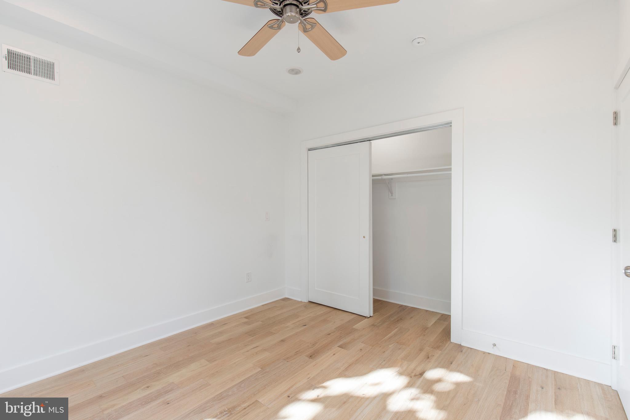 2412 Master Street, Unit A Philadelphia, PA 19121 - Photo 13 of 25 a view of a room with wooden floor and ceiling fan
