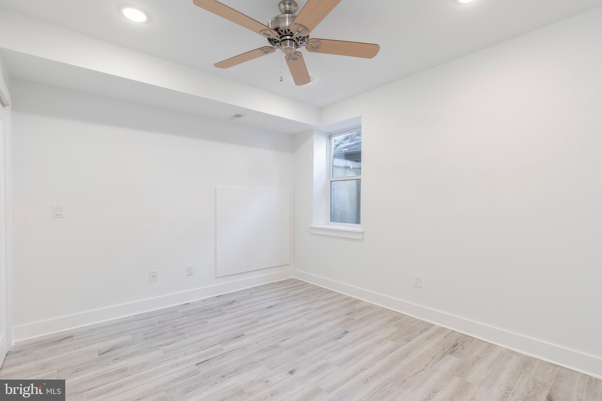 2412 Master Street, Unit A Philadelphia, PA 19121 - Photo 16 of 25 wooden floor in an empty room with a window