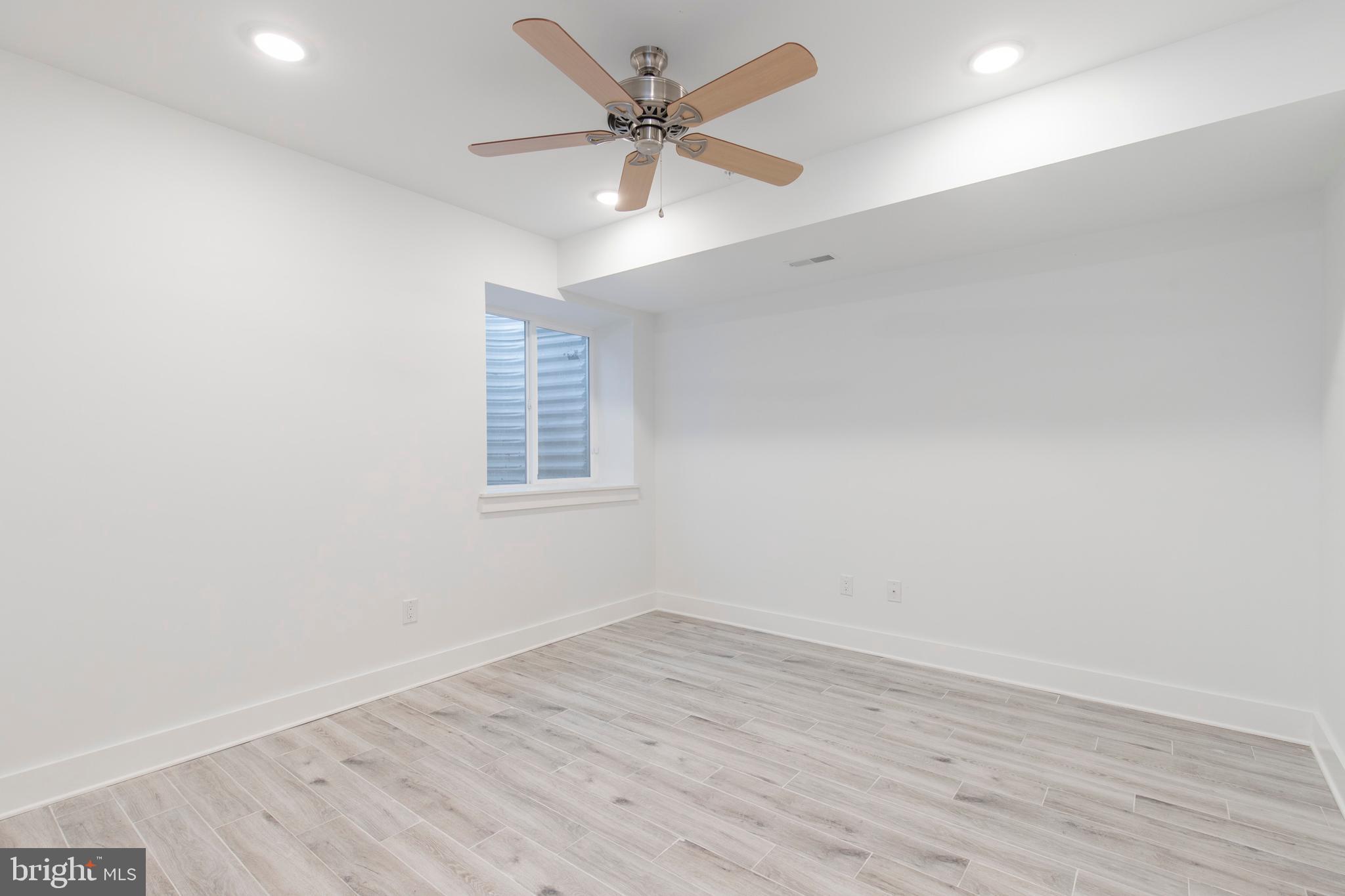 2412 Master Street, Unit A Philadelphia, PA 19121 - Photo 18 of 25 an empty room with wooden floor and windows
