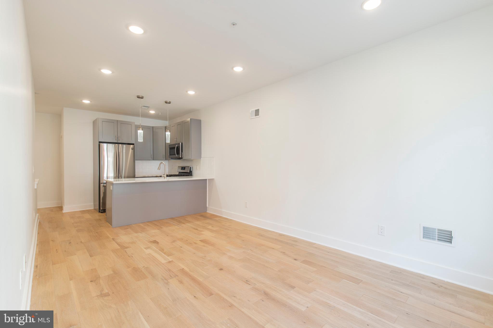 2412 Master Street, Unit A Philadelphia, PA 19121 - Photo 2 of 25 a view of kitchen with kitchen island microwave and sink