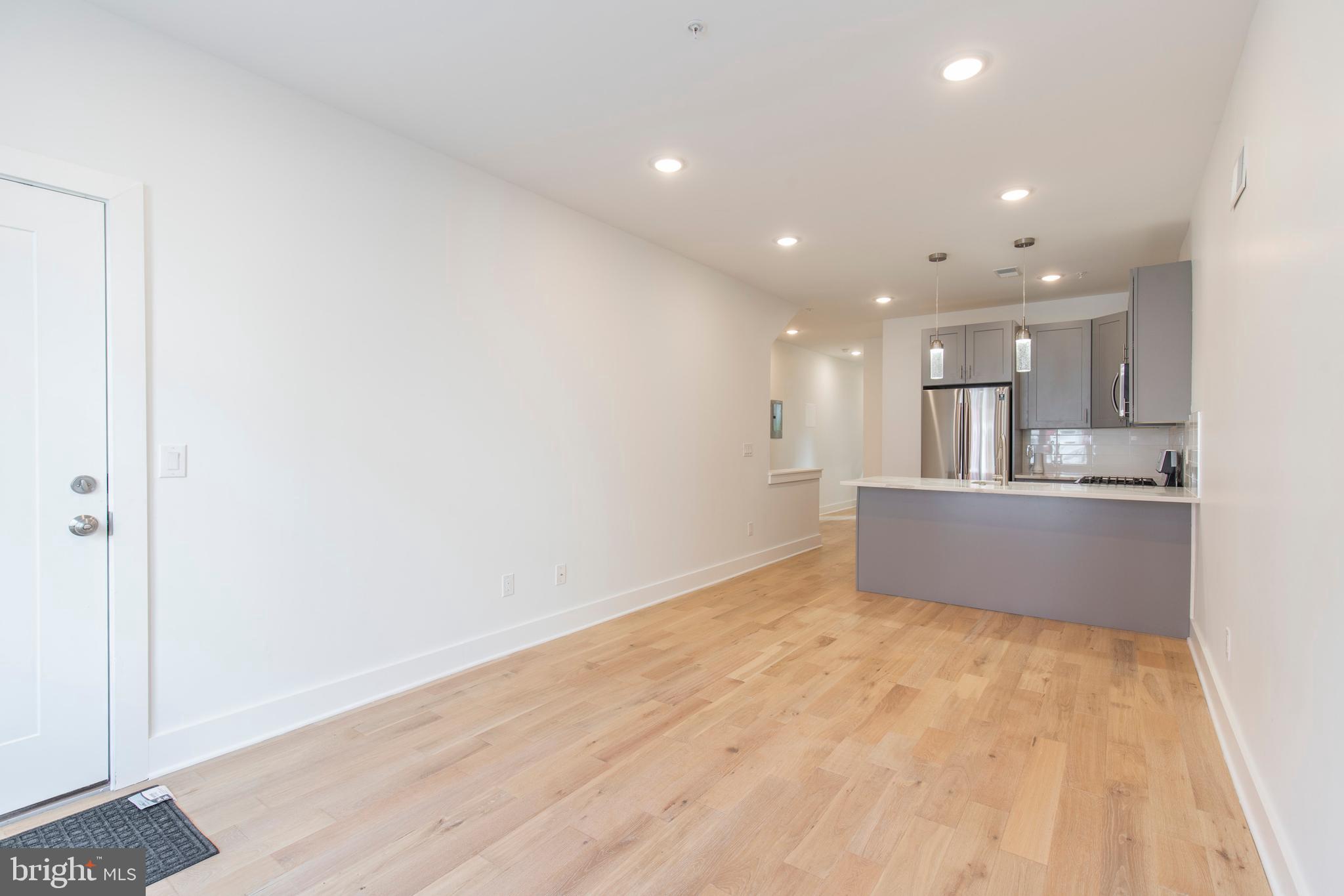 2412 Master Street, Unit A Philadelphia, PA 19121 - Photo 3 of 25 a view of kitchen with kitchen island wooden floor center island and stainless steel appliances