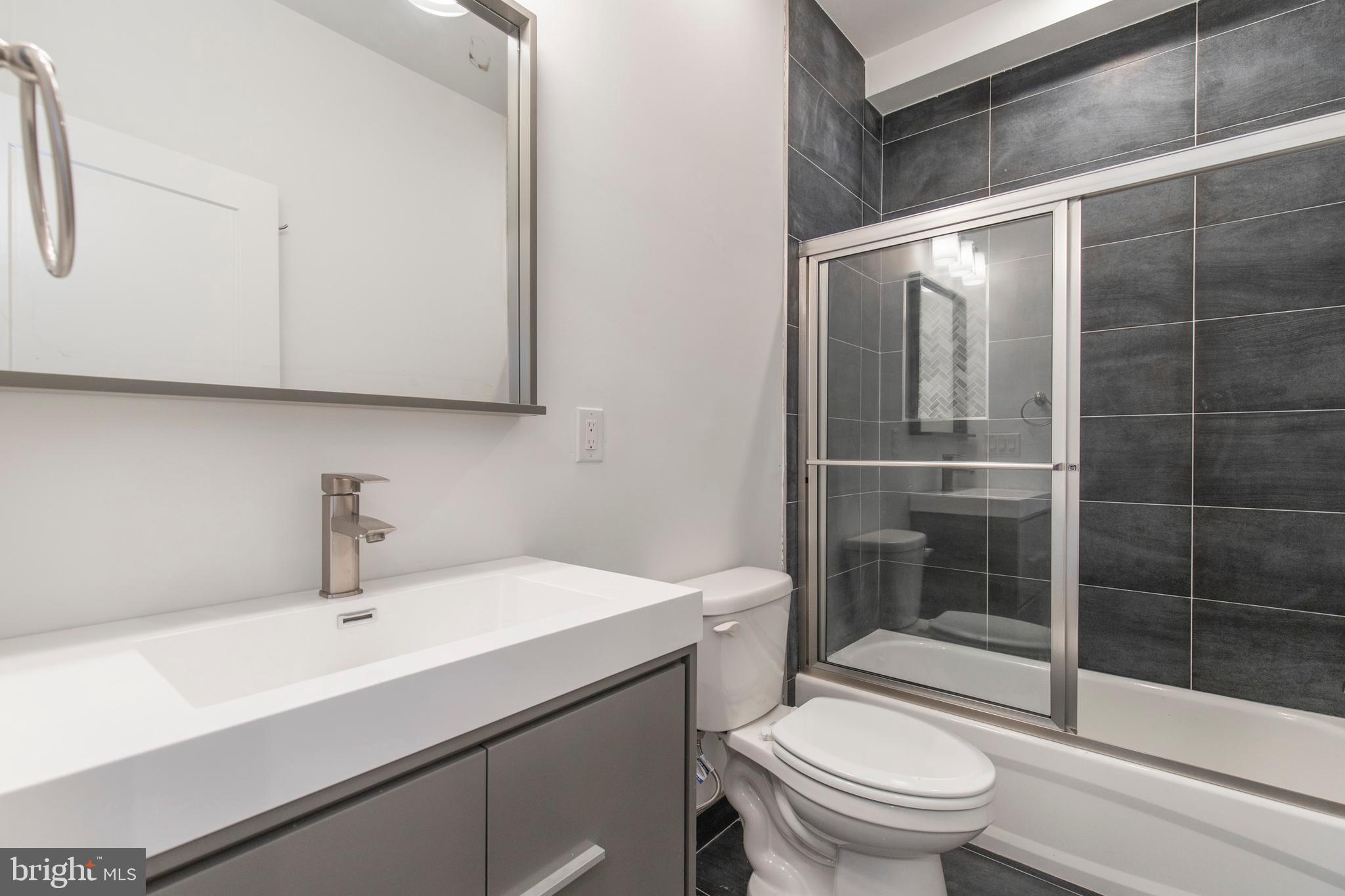 2412 Master Street, Unit A Philadelphia, PA 19121 - Photo 9 of 25 a bathroom with a sink toilet and shower
