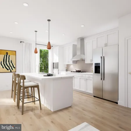 a kitchen with stainless steel appliances granite countertop a refrigerator a sink dishwasher a stove and white cabinets with wooden floor