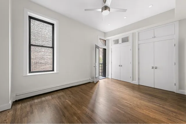 a view of a dining room with furniture a chandelier and wooden floor
