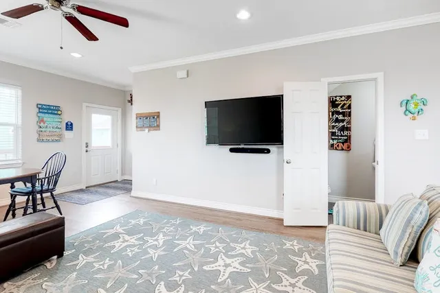 a living room with furniture and a flat screen tv