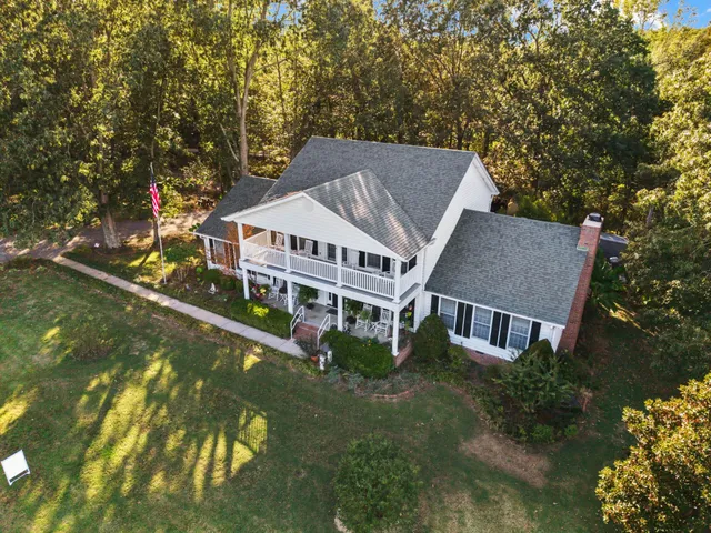 a aerial view of a house with swimming pool next to a yard