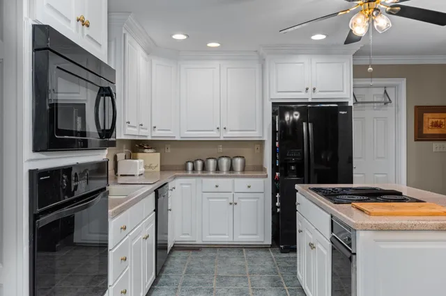 a kitchen with stainless steel appliances granite countertop a refrigerator stove and sink