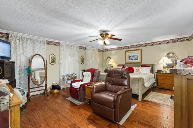 a bedroom with furniture and wooden floor
