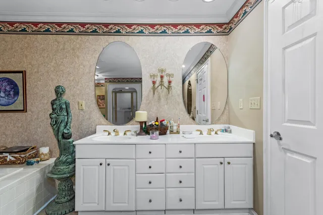 a bathroom with a double vanity sink and a mirror with toilet