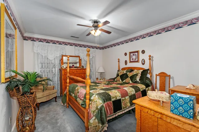 a bedroom with bed and a chandelier