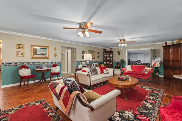 a living room with furniture kitchen view and a dining table