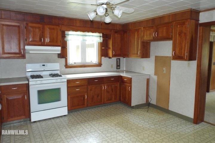 3492 South Eby's Mill Road Elizabeth, IL 61028 - Photo 2 of 20 a kitchen with a stove a sink and a refrigerator
