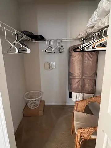 a view of storage and utility room with two washing machine