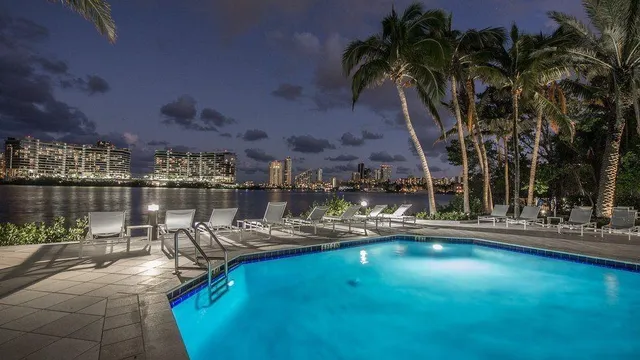 a view of a swimming pool with outdoor seating