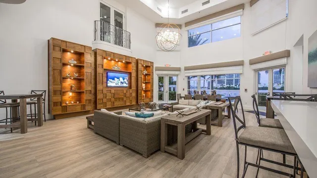 a living room with fireplace furniture and a large window
