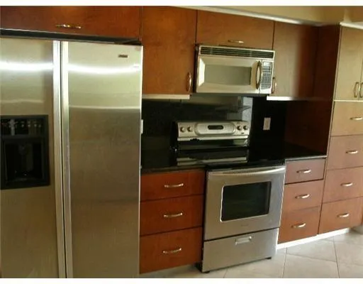 a kitchen with granite countertop a stove and a microwave