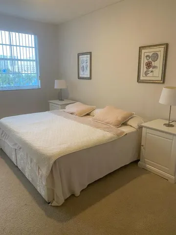 a bed sitting in a bedroom next to a window