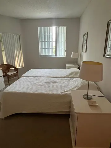 a bedroom with a bed and a chair