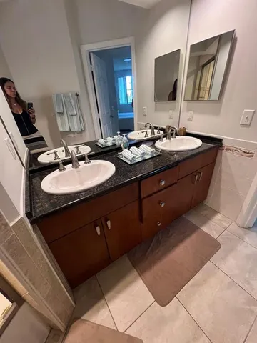 a bathroom with a sink vanity and mirror