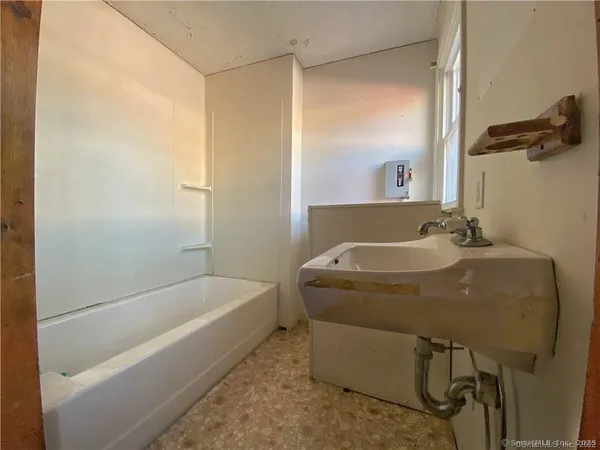 a bathroom with a tub and a shower