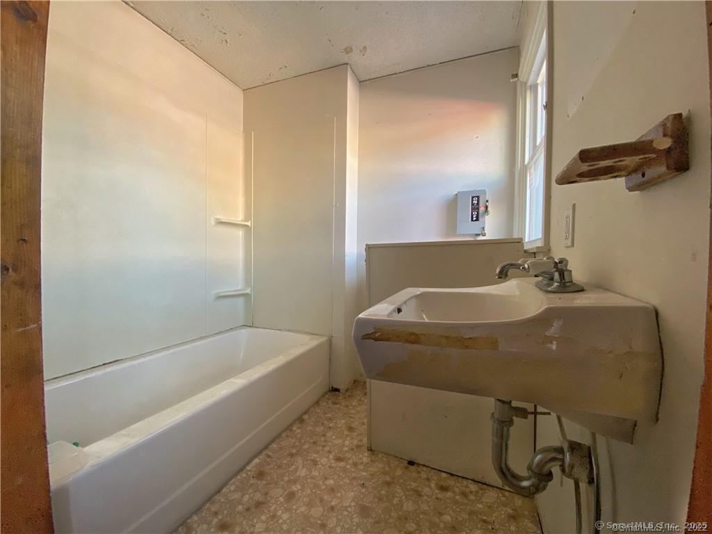 57 Main Street Winchester, CT 06098 - Photo 11 of 27 a bathroom with a tub and a shower