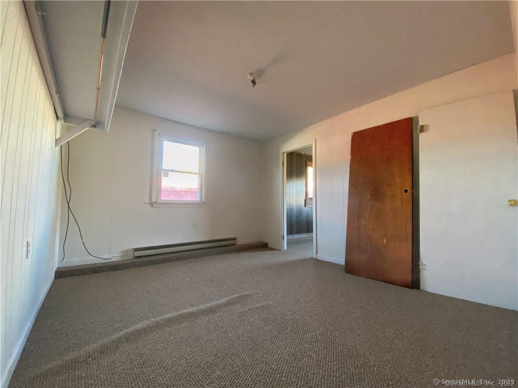 57 Main Street Winchester, CT 06098 - Photo 23 of 27 a view of an empty room with a window