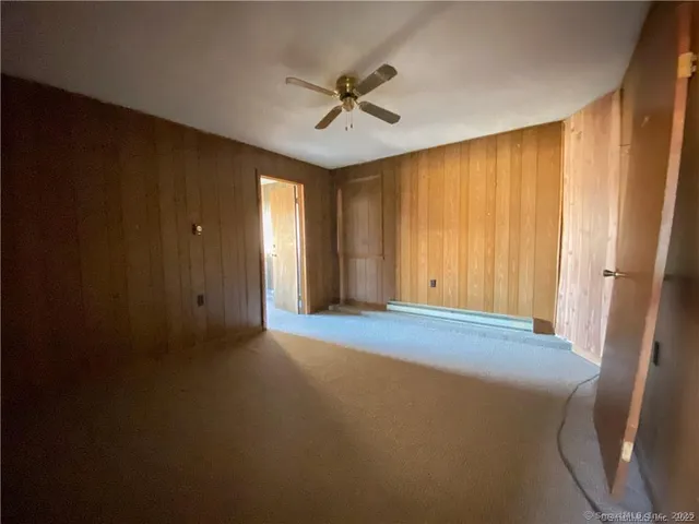 a view of a livingroom with a ceiling fan and window