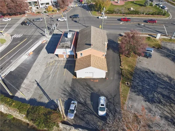 an aerial view of a house with a yard
